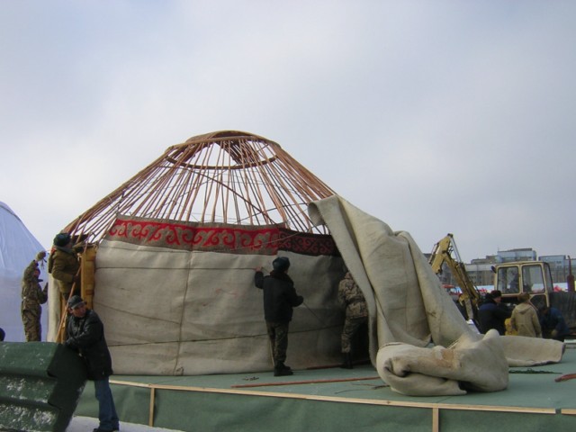 A more traditional yurt, where the felt walls are wrapped around the walls and the roof is then thrown on top.