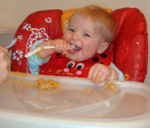 Feeding Herself With One Spoon...